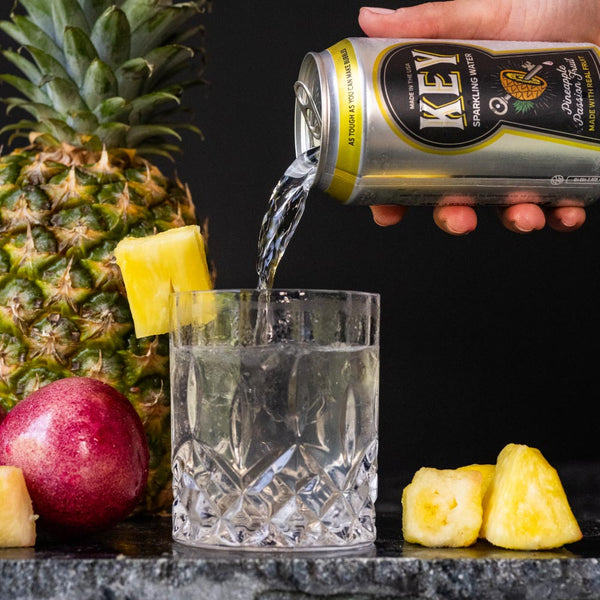 Key Sparkling Water Pineapple Passion Fruit Can Pouring into Glass