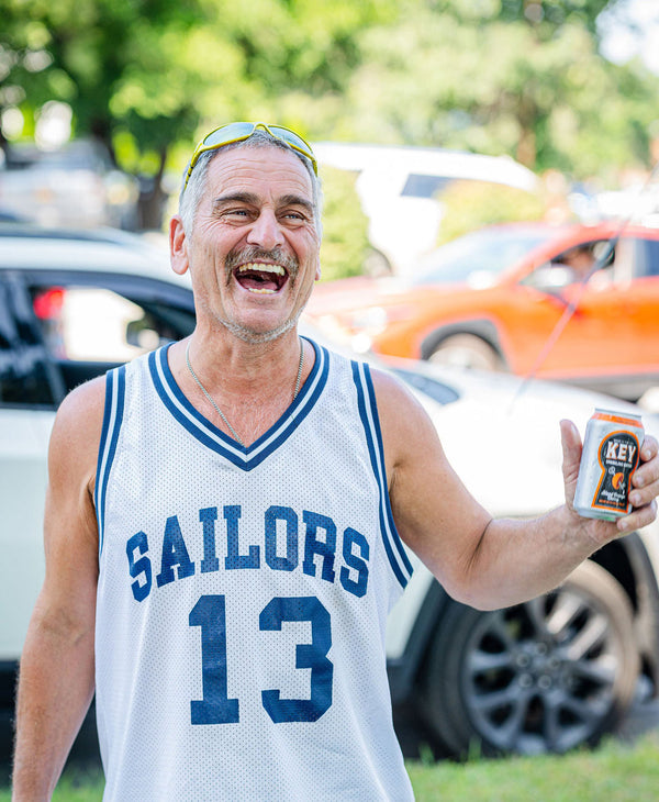 laughing man, holding can of key sparkling water