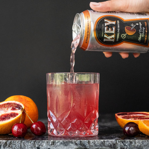 Key Sparkling Water Blood Orange Cherry Can Pouring into Glass